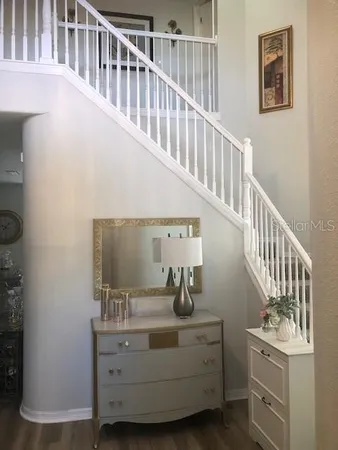 a view of staircase with wooden floor and a sink