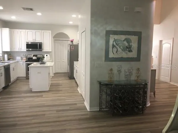 a kitchen with stainless steel appliances granite countertop a refrigerator sink and stove