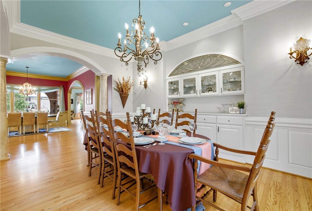 2328 Spindrift Road Virginia Beach, VA 23451 - Photo 5 of 50 Dining area with a chandelier, arched walkways, ornamental molding, decorative columns, and light wood-type flooring