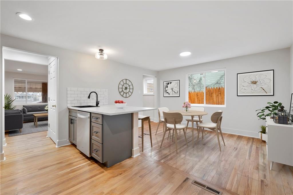 806 Ridge Avenue McKees Rocks, PA 15136 - Photo 12 of 30 a view of a kitchen area with furniture and wooden floor