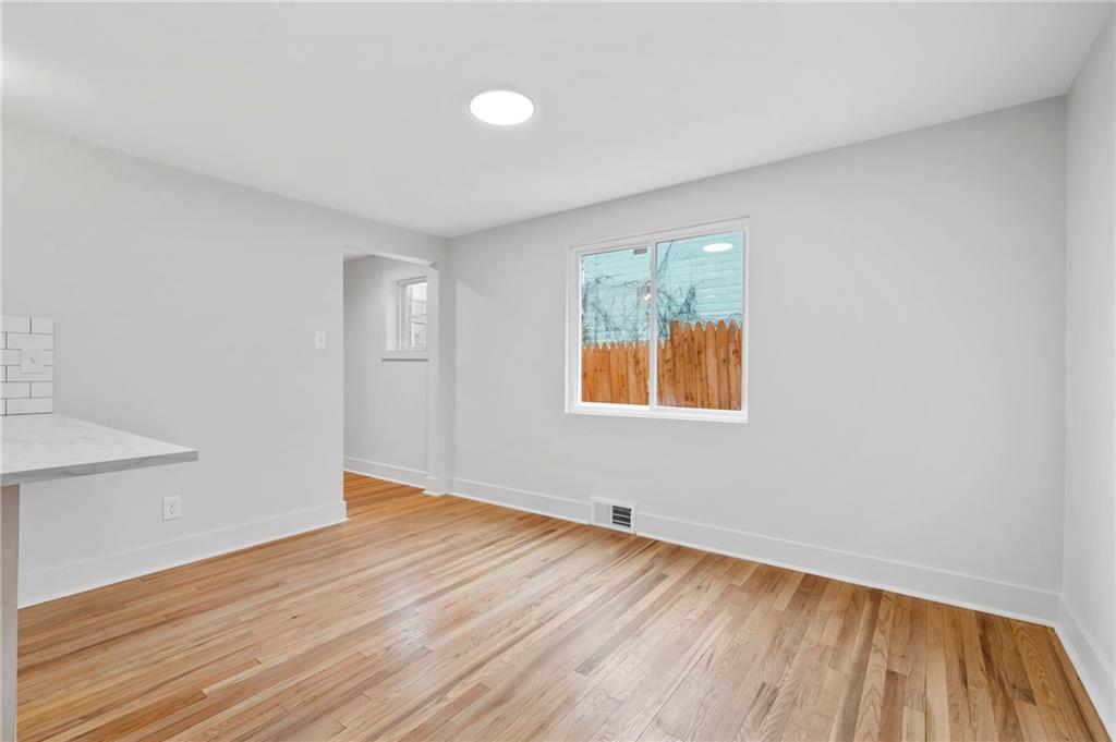 806 Ridge Avenue McKees Rocks, PA 15136 - Photo 13 of 30 an empty room with wooden floor and windows