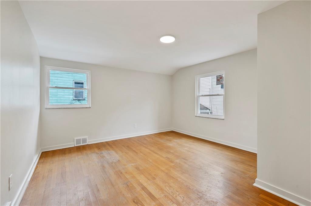 806 Ridge Avenue McKees Rocks, PA 15136 - Photo 23 of 30 an empty room with a wooden floor and a window