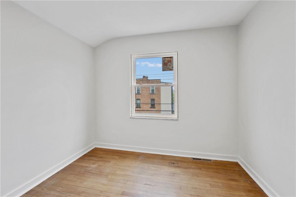 806 Ridge Avenue McKees Rocks, PA 15136 - Photo 25 of 30 a view of an empty room with wooden floor and a window