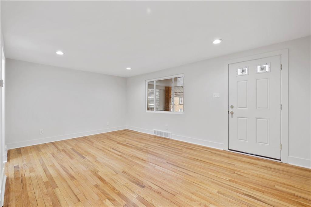 806 Ridge Avenue McKees Rocks, PA 15136 - Photo 7 of 30 a view of empty room with wooden floor and fan