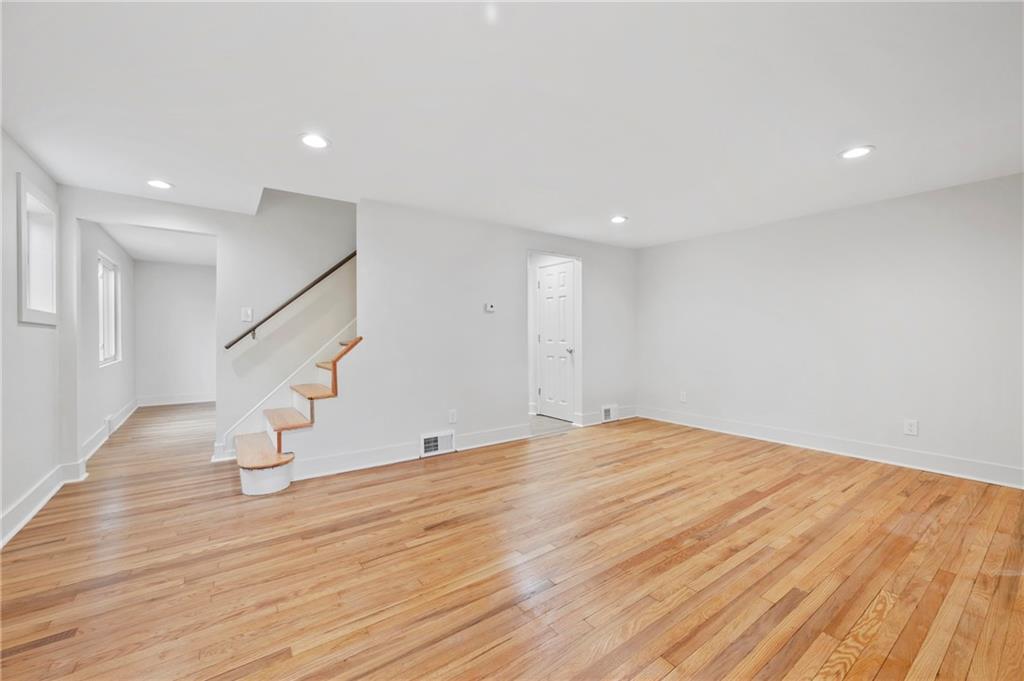 806 Ridge Avenue McKees Rocks, PA 15136 - Photo 8 of 30 a view of an empty room with wooden floor and stairs