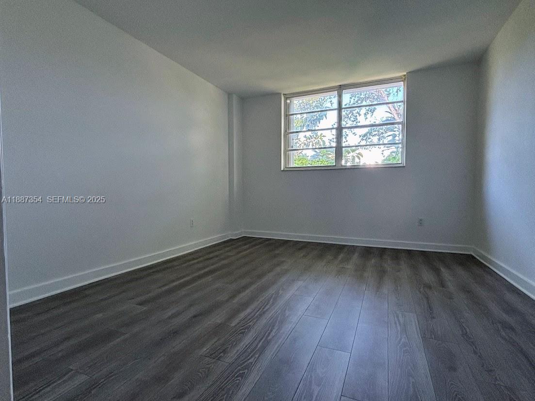 680 Northeast 64th Street, Unit A516 Miami, FL 33138 - Photo 11 of 54 an empty room with wooden floor and windows