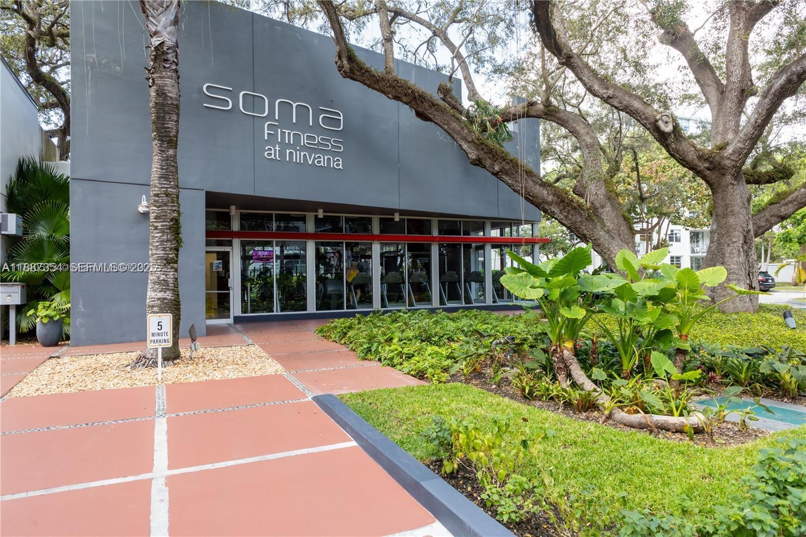 680 Northeast 64th Street, Unit A516 Miami, FL 33138 - Photo 30 of 54 a view of a house with a small yard and potted plants