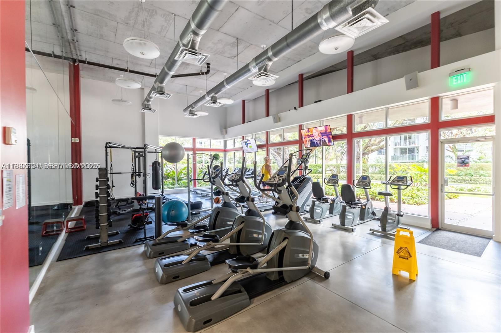 680 Northeast 64th Street, Unit A516 Miami, FL 33138 - Photo 31 of 54 a view of a room with gym equipment