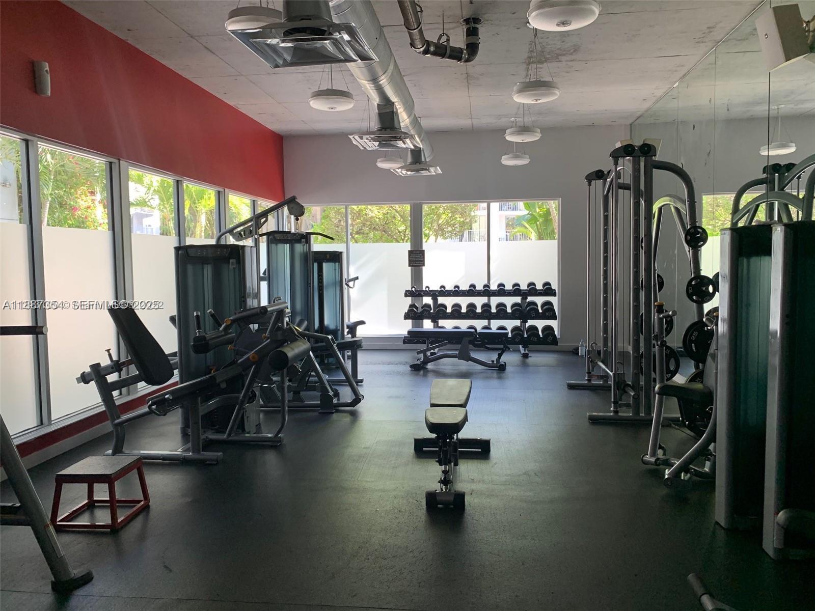 680 Northeast 64th Street, Unit A516 Miami, FL 33138 - Photo 32 of 54 a view of a room with gym equipment