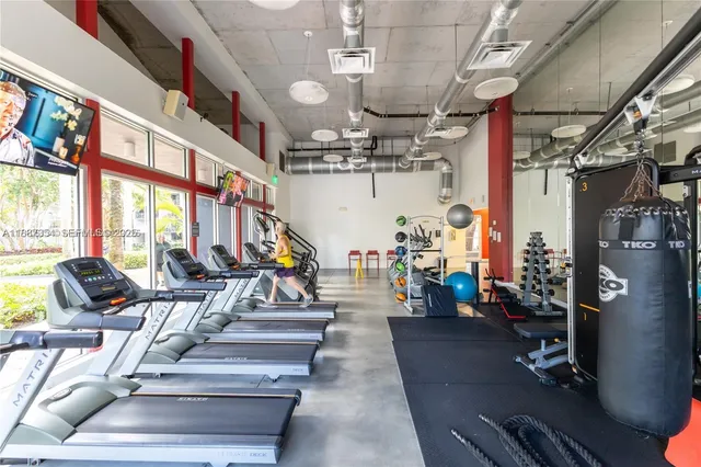 a view of a room with gym equipment and a large window