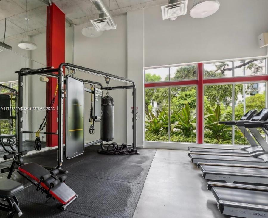 680 Northeast 64th Street, Unit A516 Miami, FL 33138 - Photo 35 of 54 a view of a room with gym equipment and a large window