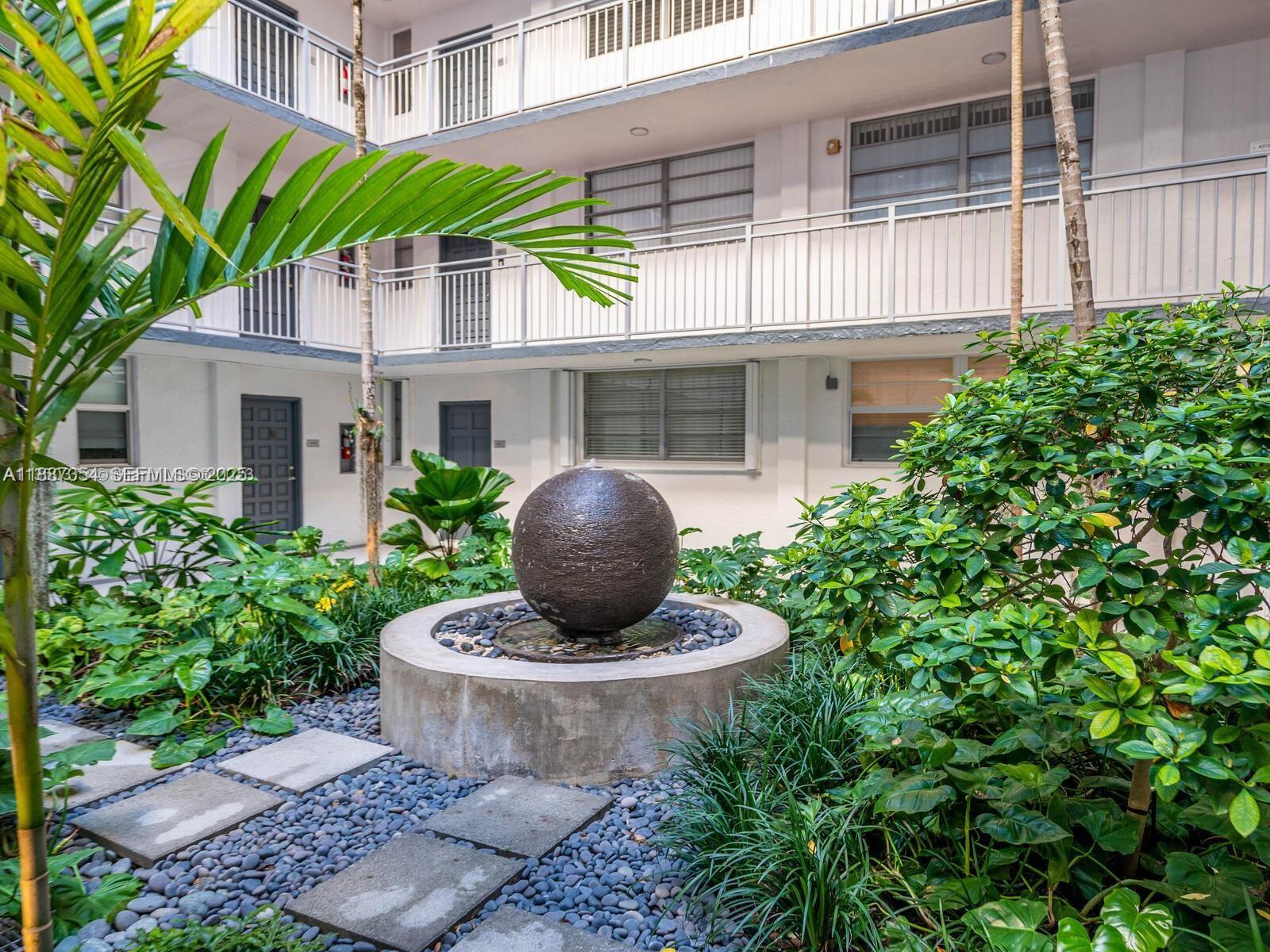 680 Northeast 64th Street, Unit A516 Miami, FL 33138 - Photo 44 of 54 a front view of a house with a garden