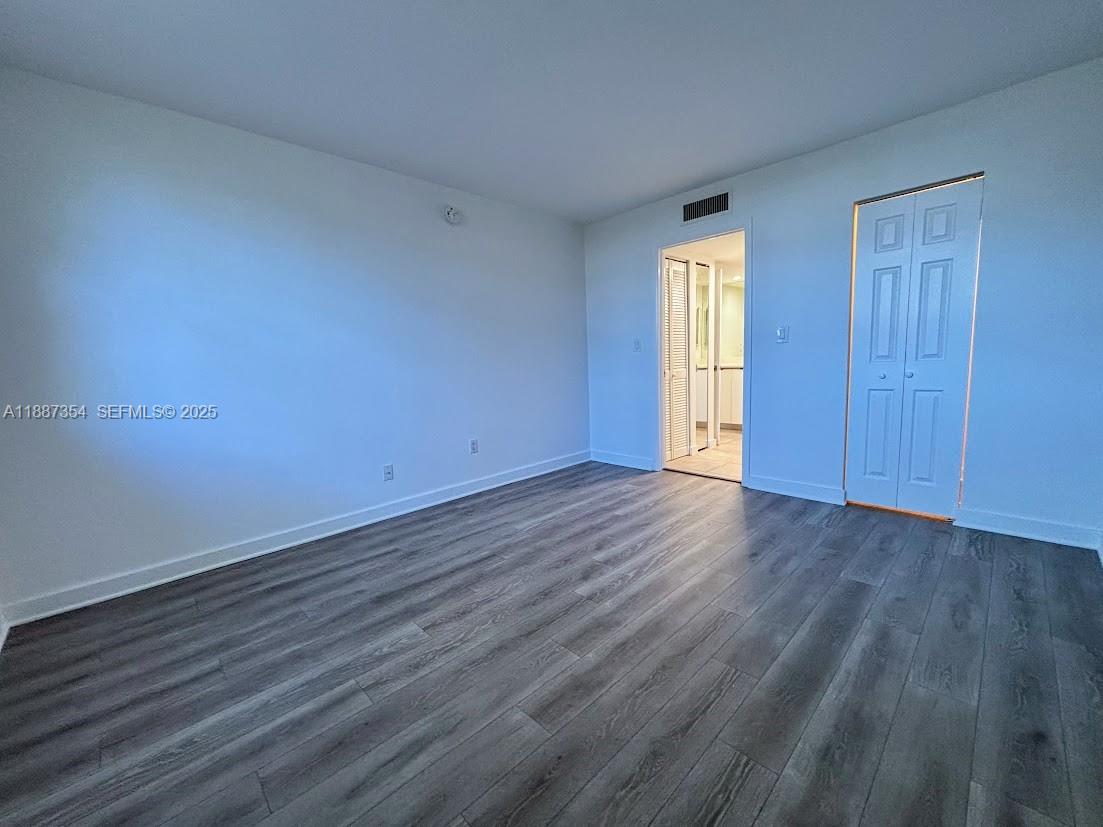 680 Northeast 64th Street, Unit A516 Miami, FL 33138 - Photo 10 of 54 an empty room with wooden floor and windows