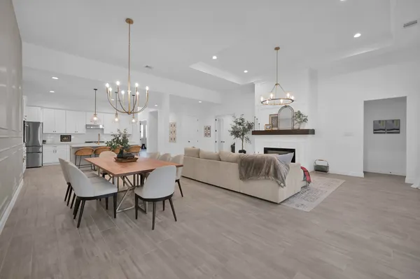 a living room with fireplace furniture and a chandelier