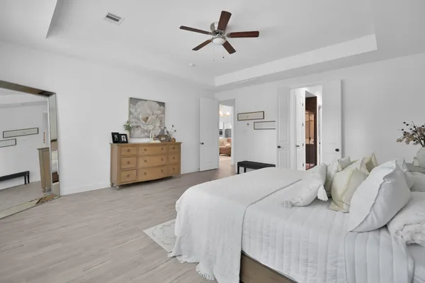 a bedroom with a bed and a chandelier