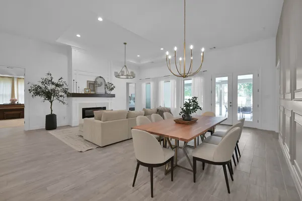 a view of a dining room with furniture and chandelier