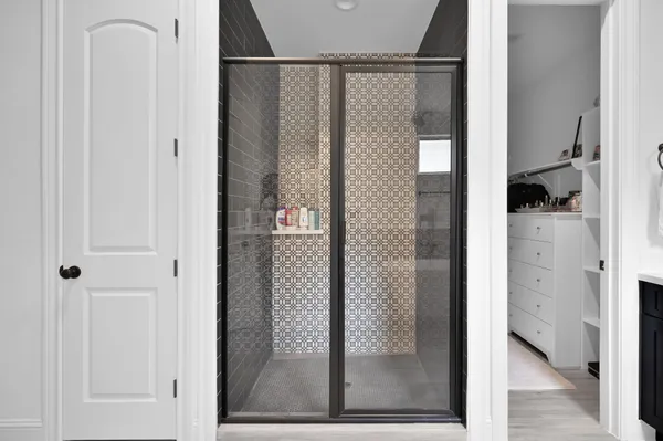 a bathroom with a glass shower door