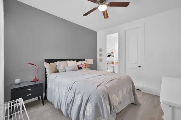 a bedroom with a bed and a chandelier