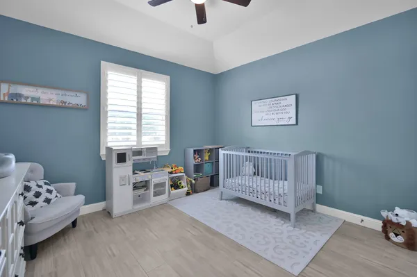 a bedroom with a bed and a chair