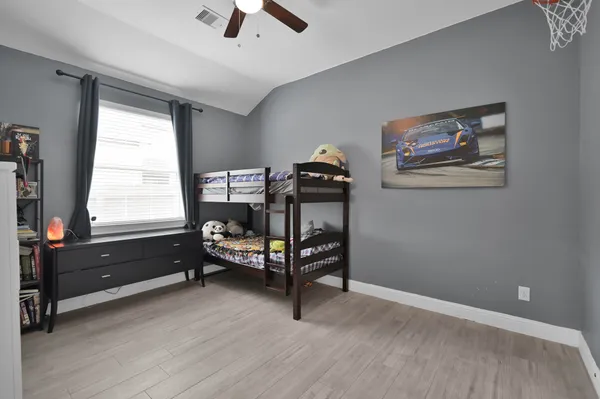 a bedroom with furniture and a window