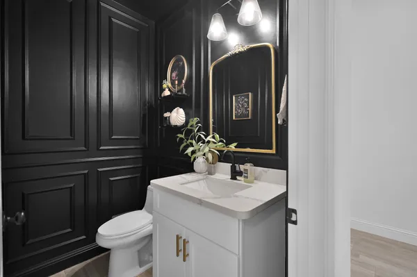 a bathroom with a sink a toilet and mirror
