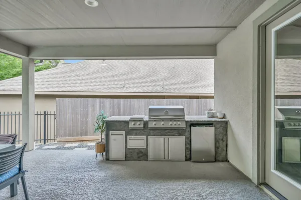 a living room with furniture a window and kitchen view