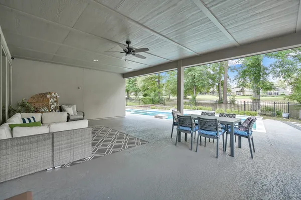 a dining room with furniture and a floor to ceiling window
