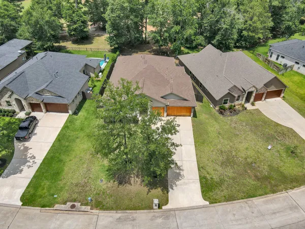 an aerial view of a house with garden space and lake view