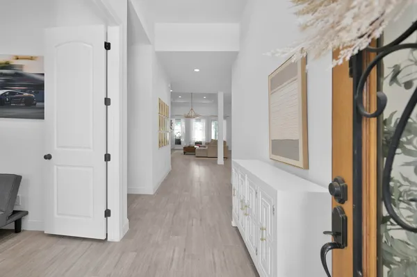 a view of hallway with wooden floor