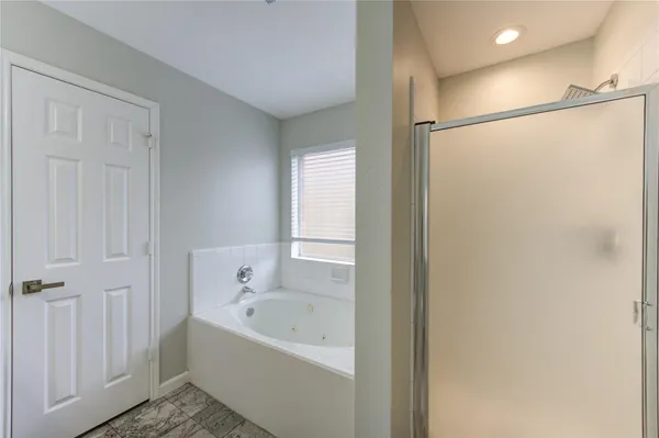 a bathroom with a bathtub and a shower