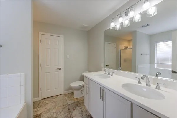 a bathroom with a double vanity sink and a mirror
