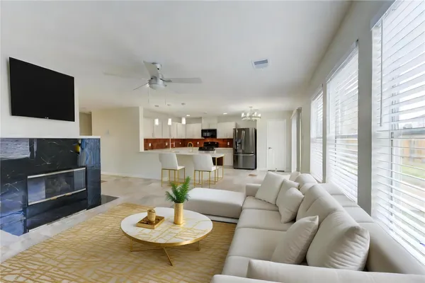 a living room with furniture and a fireplace