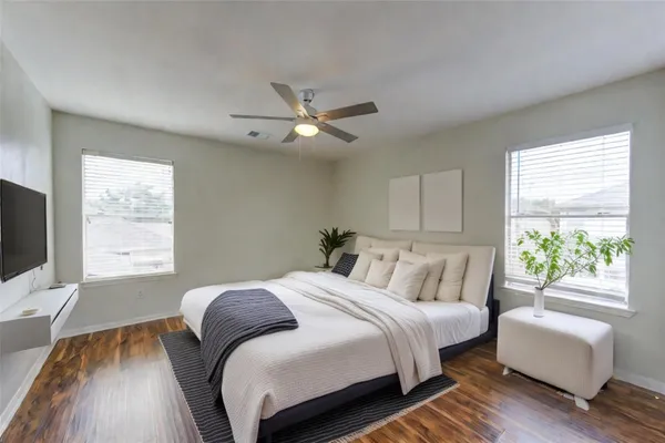 a bedroom with a large bed and a flat screen tv