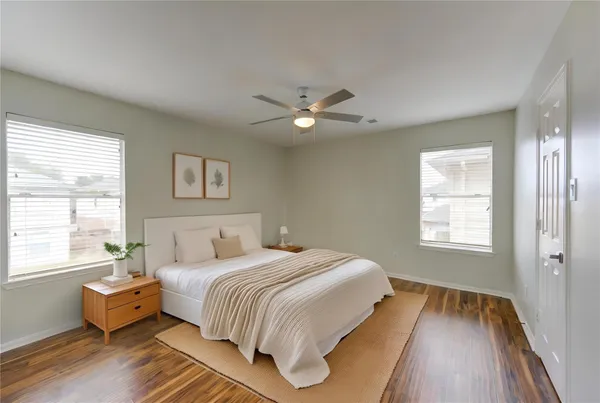 a bedroom with a bed and a large window