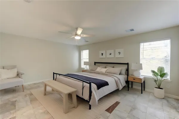 a spacious bedroom with a bed and window