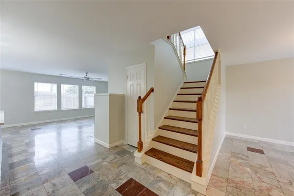 a view of entryway with stairs and wooden floor