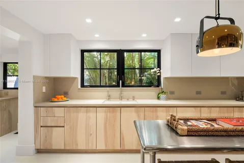 a kitchen with stainless steel appliances kitchen island granite countertop a sink and cabinets