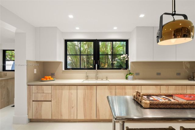 a kitchen with stainless steel appliances kitchen island granite countertop a sink and cabinets