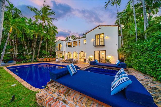 a view of a house with pool and chairs