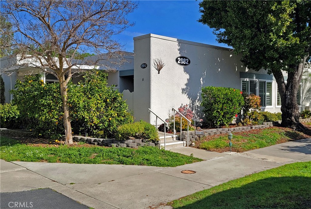 a front view of a house with a yard and a garage