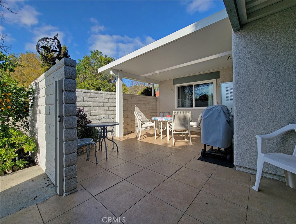 2082 Ronda Granada, Unit D Laguna Woods, CA 92637 - Photo 14 of 36 a view of a patio with table and chairs and potted plants