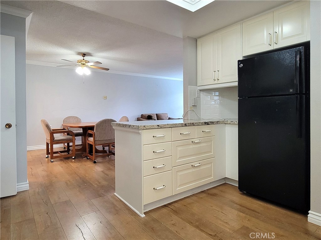 2082 Ronda Granada, Unit D Laguna Woods, CA 92637 - Photo 23 of 36 a kitchen with a cabinets and a refrigerator