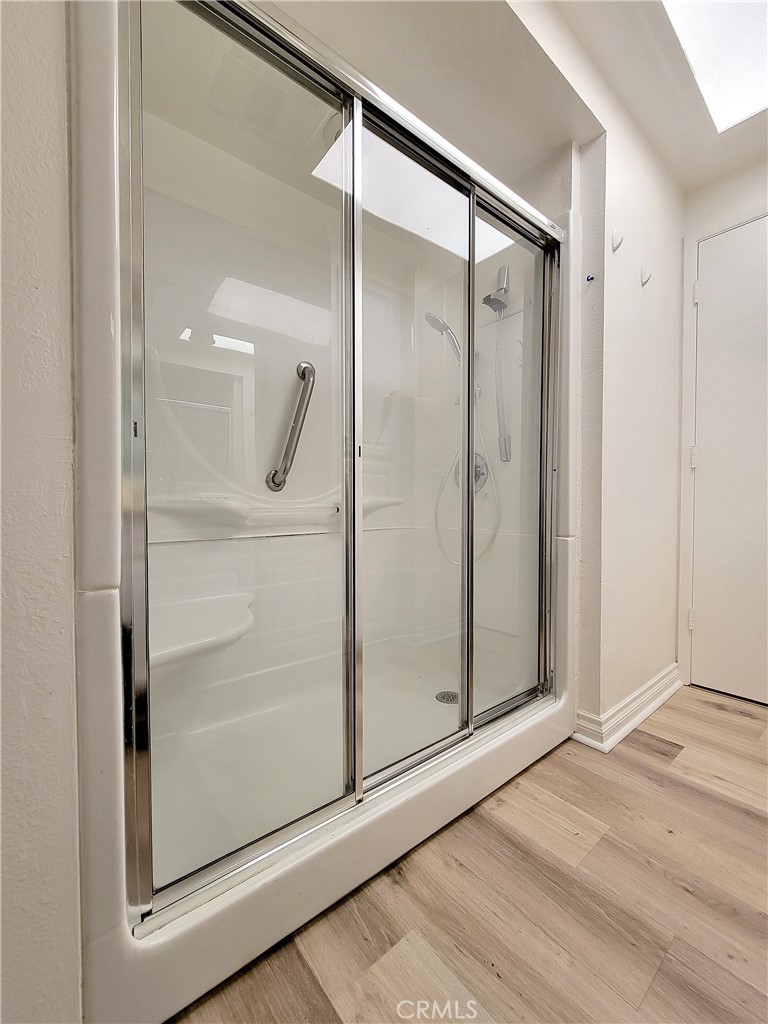 2082 Ronda Granada, Unit D Laguna Woods, CA 92637 - Photo 30 of 36 a bathroom with a glass shower door