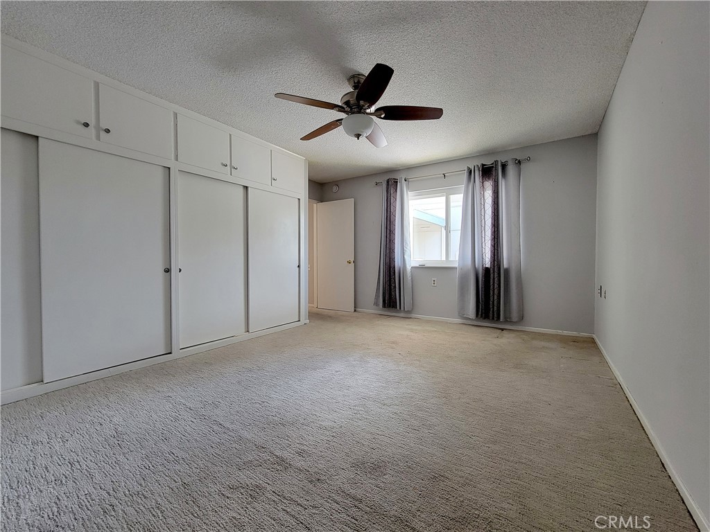 2082 Ronda Granada, Unit D Laguna Woods, CA 92637 - Photo 32 of 36 a view of an empty room with a ceiling fan