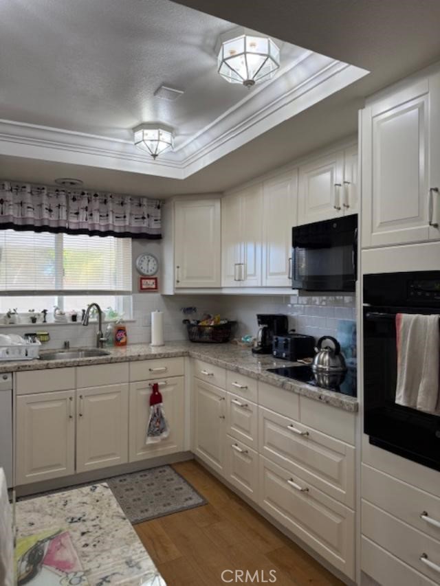 2082 Ronda Granada, Unit D Laguna Woods, CA 92637 - Photo 5 of 36 a kitchen with granite countertop a sink and cabinets
