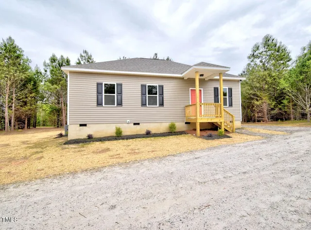a view of a house with a snow on the road