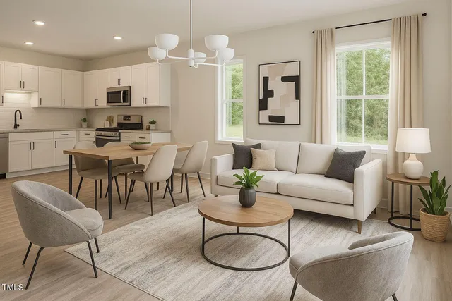 a living room with furniture kitchen view and a window