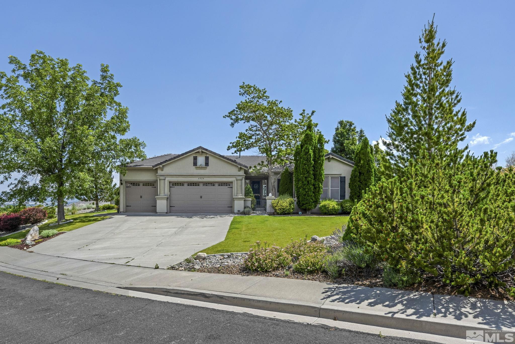 6824 Marble Canyon Road Reno, NV 89511 - Photo 1 of 30 a front view of a house with a garden