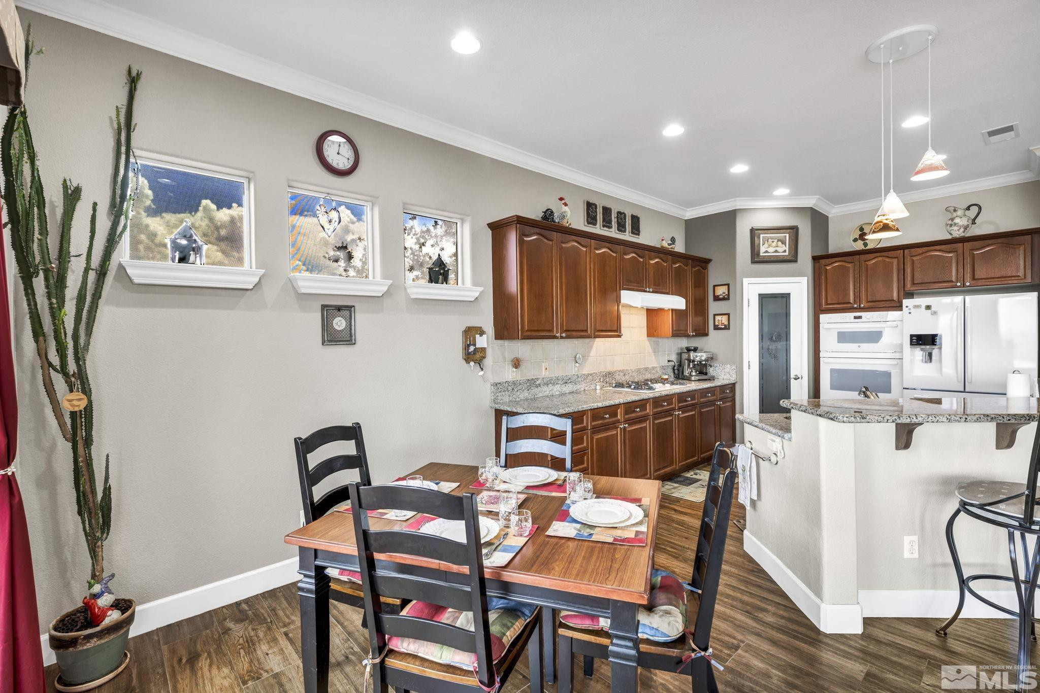 6824 Marble Canyon Road Reno, NV 89511 - Photo 12 of 30 a view of a dining room with furniture and wooden floor