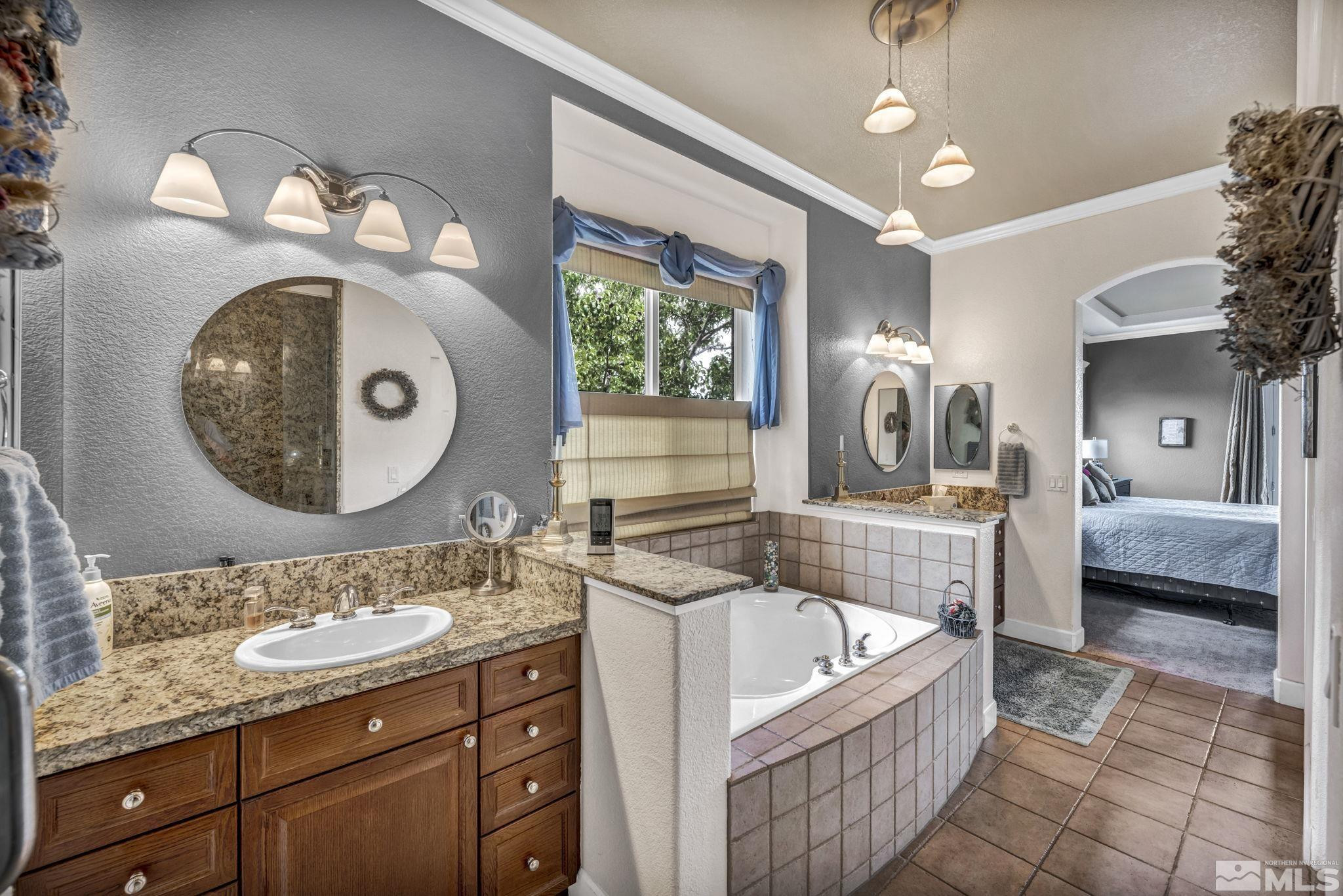 6824 Marble Canyon Road Reno, NV 89511 - Photo 20 of 30 a bathroom with a granite countertop bathtub sink vanity and mirror
